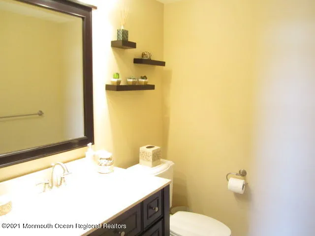 a bathroom with a sink a toilet and mirror