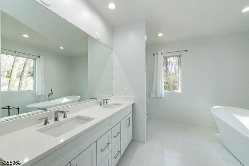 34 West Shore Road Mountain Lakes, NJ 07046 - Photo 29 of 46 a bathroom with double vanity sink a mirror and a bathtub