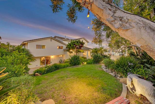 a living room with patio furniture and a potted plant