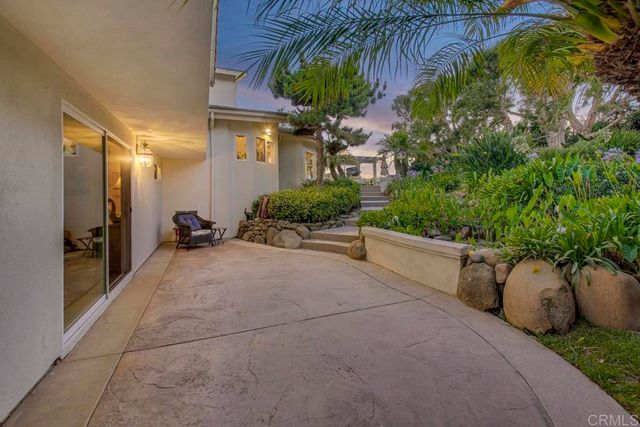 an aerial view of a house with a garden and plants