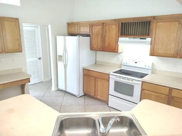 a kitchen with stainless steel appliances granite countertop a sink and cabinets