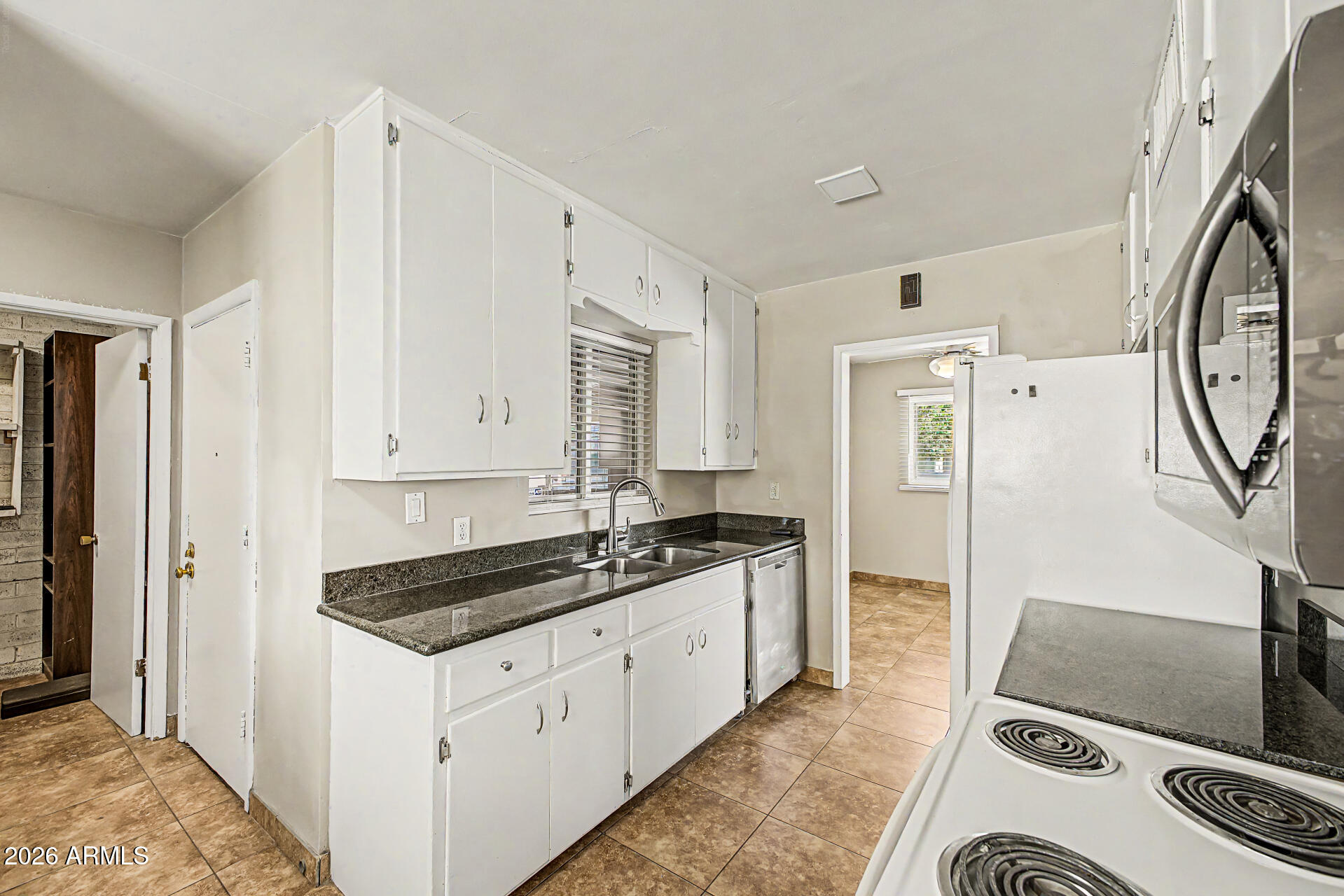 2022 East Monterey Way Phoenix, AZ 85016 - Photo 9 of 29 a kitchen with granite countertop a stove and a sink