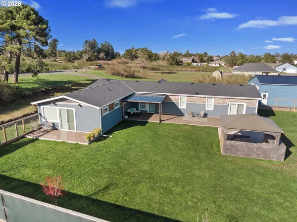 an aerial view of a house with swimming pool garden and mountain view
