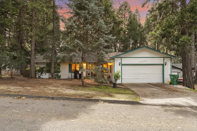 a view of a house with a yard and garage