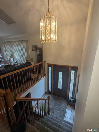 a view of staircase with railing and a window