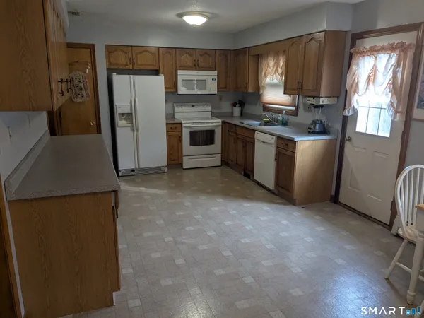 a kitchen with a refrigerator sink and stove