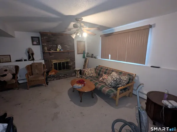 a living room with furniture and a fireplace