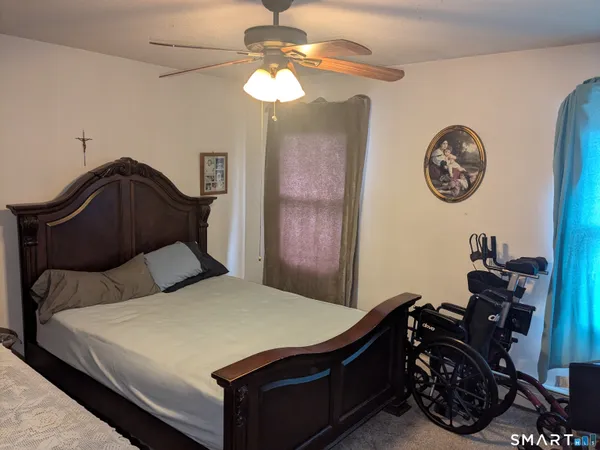 a bedroom with a bed and a chandelier