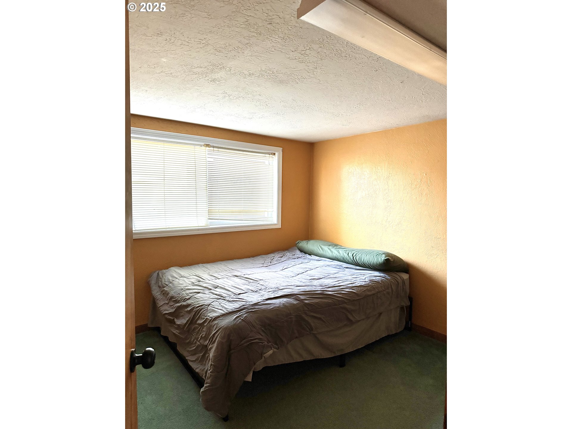 59720 Highway 26 John Day, OR 97845 - Photo 20 of 22 a bed sitting in a bedroom next to a window