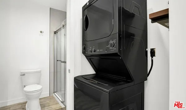 a bathroom with a toilet and a mirror