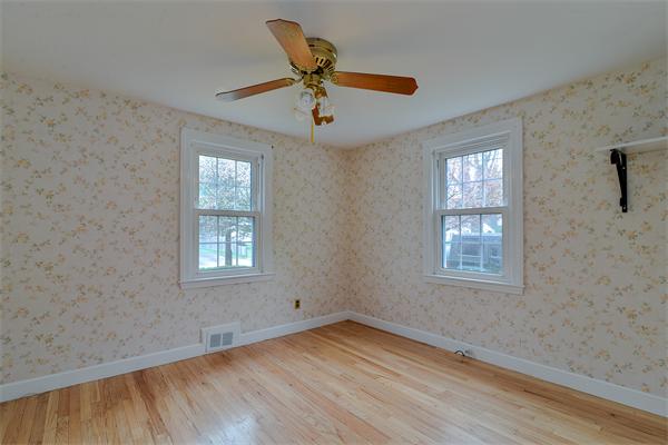 22 Stratford Road Natick, MA 01760 - Photo 12 of 18 an empty room with windows and ceiling fan