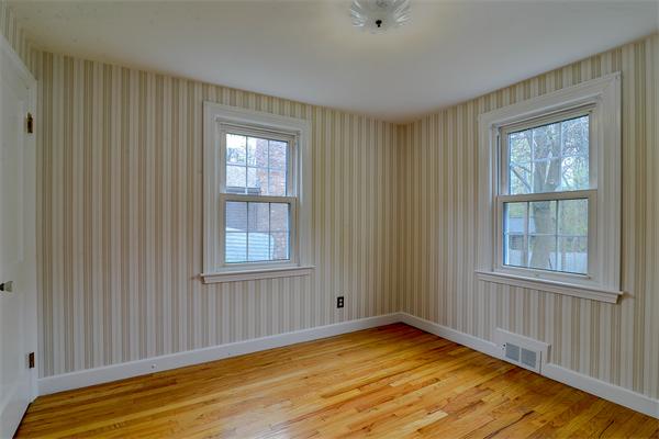 22 Stratford Road Natick, MA 01760 - Photo 13 of 18 a view of an empty room with wooden floor and a window