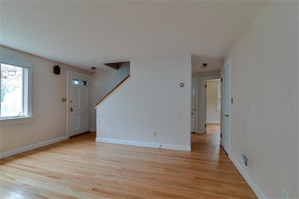 22 Stratford Road Natick, MA 01760 - Photo 14 of 18 a view of an empty room with wooden floor and a window