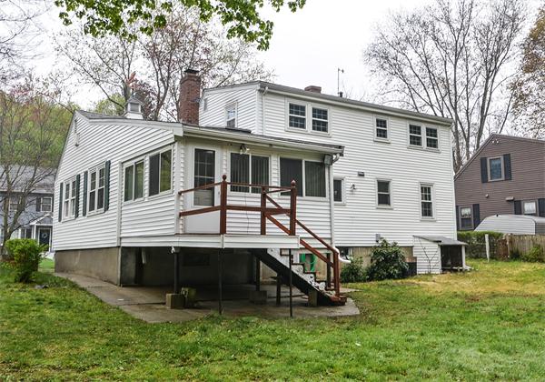 22 Stratford Road Natick, MA 01760 - Photo 17 of 18 a front view of a house with a yard table and chairs