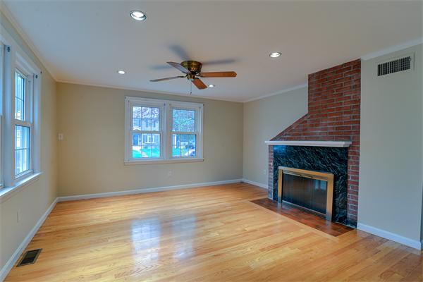 22 Stratford Road Natick, MA 01760 - Photo 8 of 18 a view of an empty room with a window and fireplace