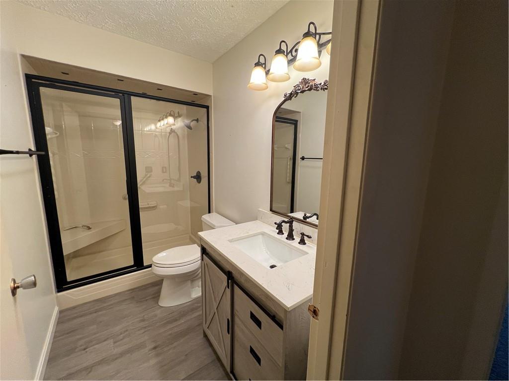 2902 Darlington Road, Unit 1002 Beaver Falls, PA 15010 - Photo 20 of 27 a bathroom with a granite countertop sink toilet and shower a mirror