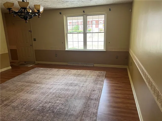 a view of a room with wooden floor and a window