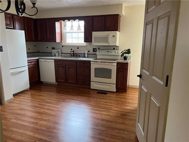 a kitchen with a sink a stove and a refrigerator