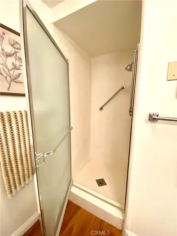 a bathroom with a glass door shower and a sink