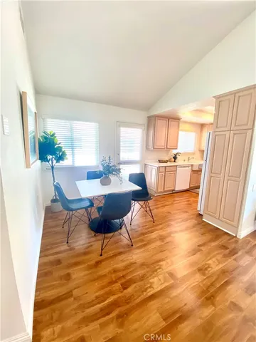 a large kitchen with a table and chairs in it