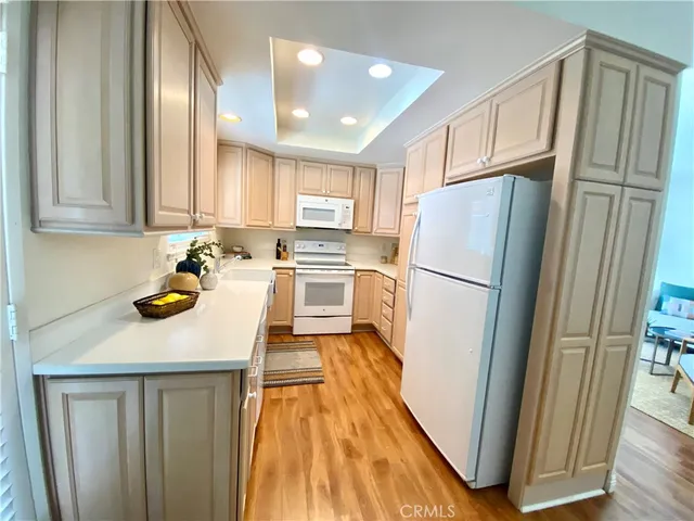 a kitchen with wooden cabinets and refrigerator