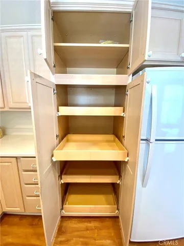 a view of walk in closet with empty racks