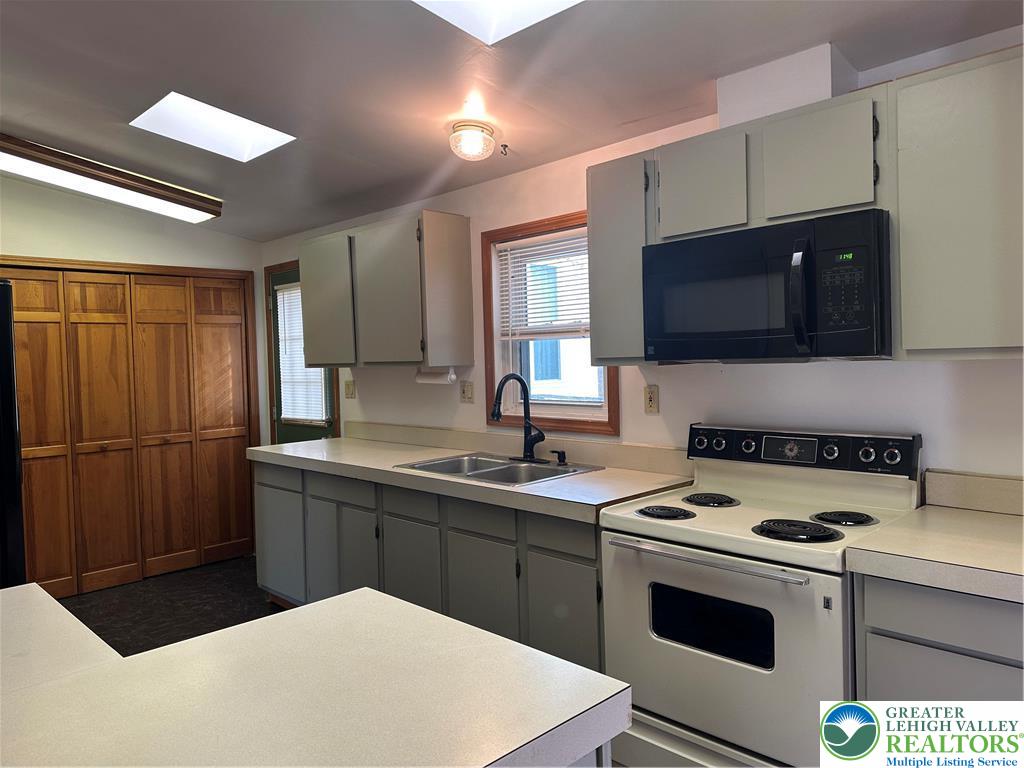 1157 Blue Barn Road Allentown, PA 18104 - Photo 6 of 23 a kitchen with a sink a stove and refrigerator