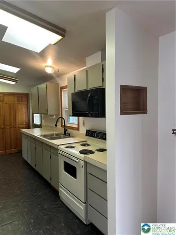 a kitchen with a sink a stove and refrigerator