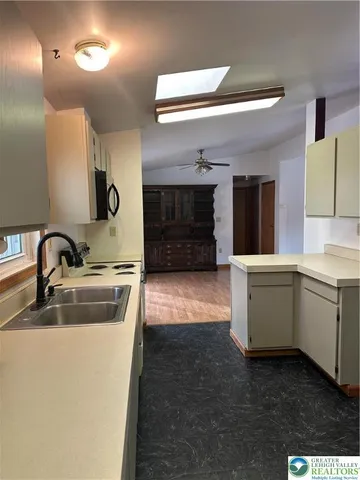 a kitchen with a sink and a refrigerator