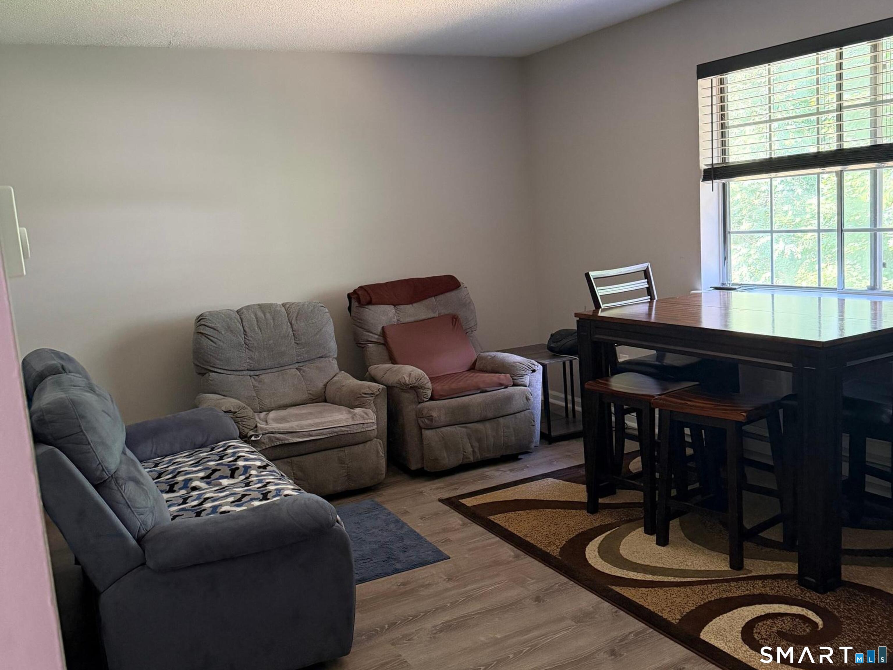 21 Lisa Court, Unit 10 Waterbury, CT 06704 - Photo 6 of 14 a living room with furniture and a window