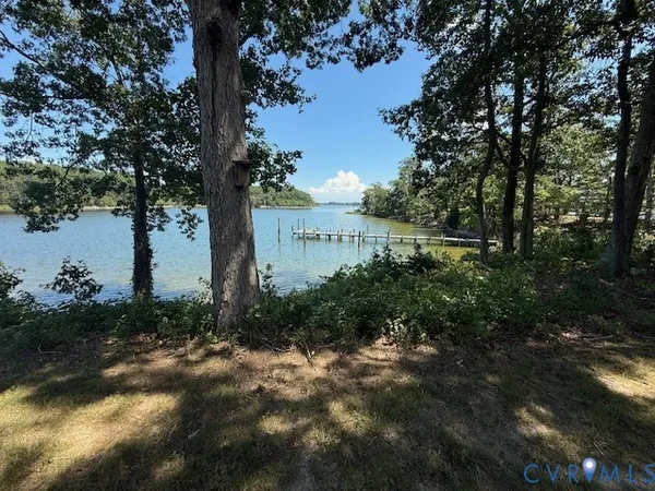 a view of a lake with a house in background