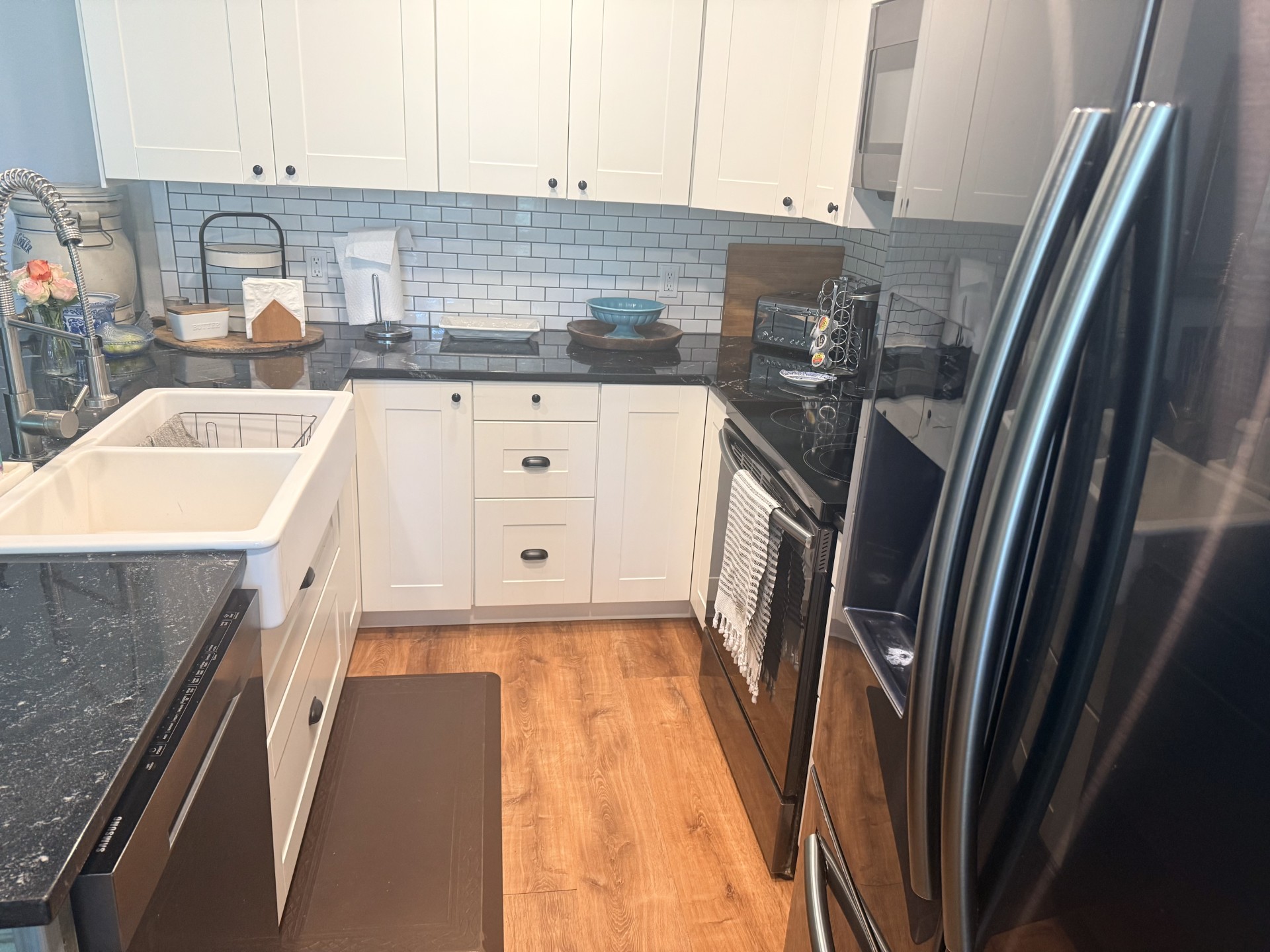227 Crooked Hollow Road Elgin, TX 78621 - Photo 4 of 11 a kitchen with a sink a refrigerator and washer