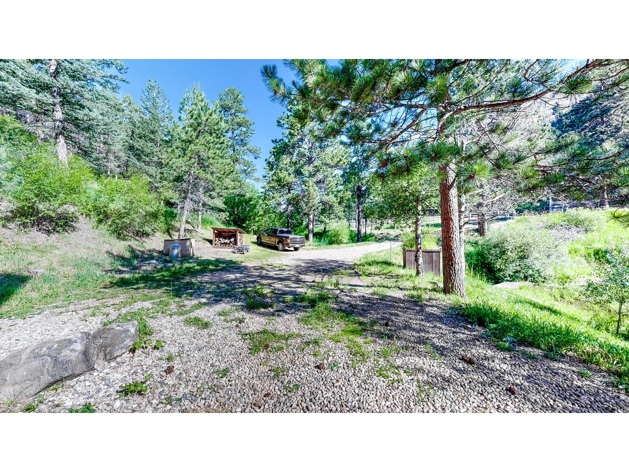 1268 Spring Valley Road Bellvue, CO 80512 - Photo 28 of 33 a backyard of a house with a yard and outdoor seating