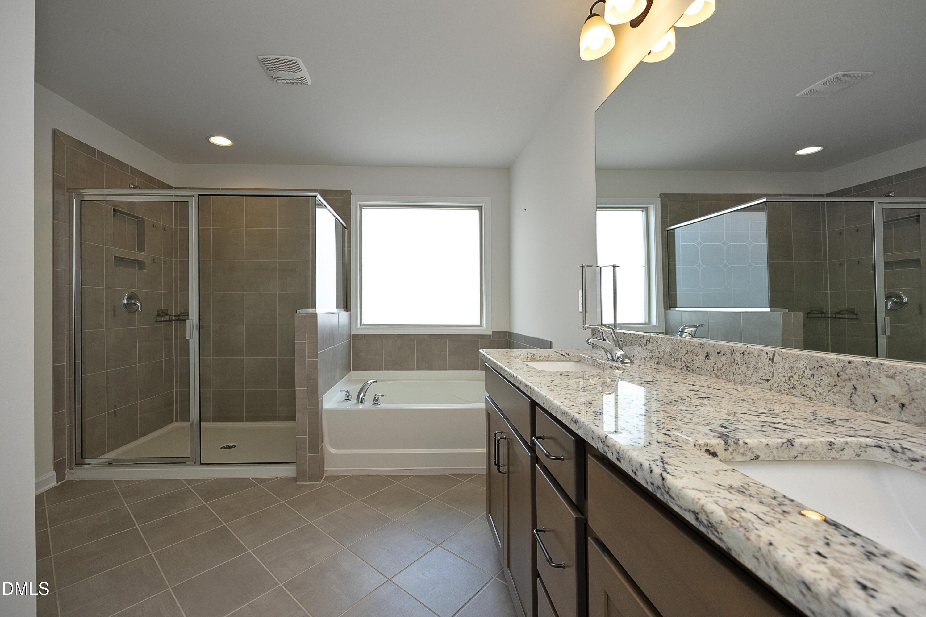 824 Country Downs Road Wake Forest, NC 27587 - Photo 22 of 41 a bathroom with a granite countertop sink a toilet and shower