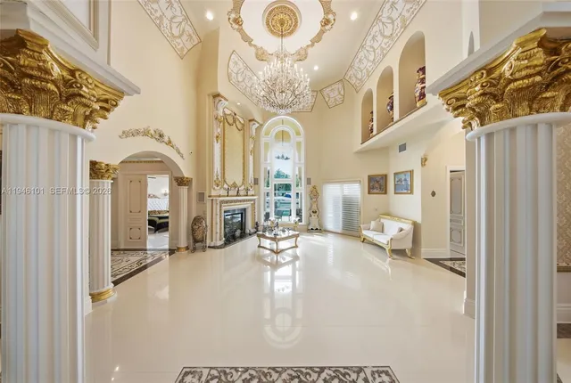 a view of a patio with couches and table and chairs with wooden floor and fence