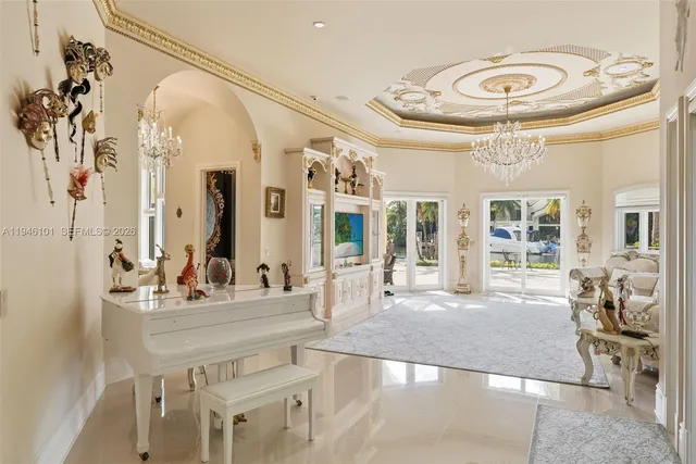 a spacious bedroom with a large bed and a chandelier