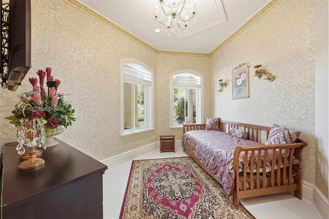 a bedroom with a large bed and a chandelier