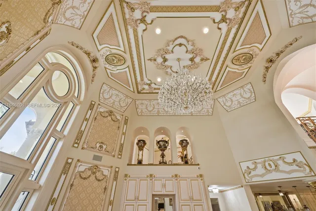 a view of a dining room with furniture a chandelier and wooden floor