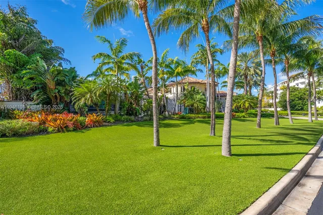 a living room with furniture a fireplace and a chandelier