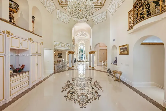 a living room with fireplace furniture and a chandelier