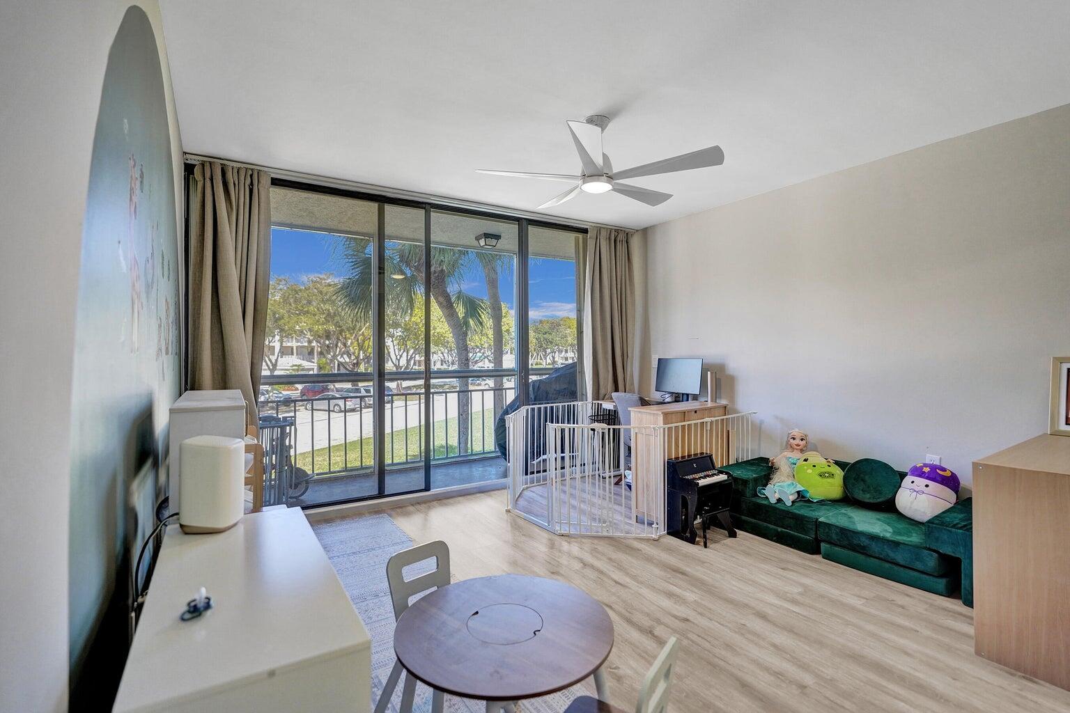 6193 Balboa Circle, Unit 201 Boca Raton, FL 33433 - Photo 24 of 62 a living room with furniture and a large window