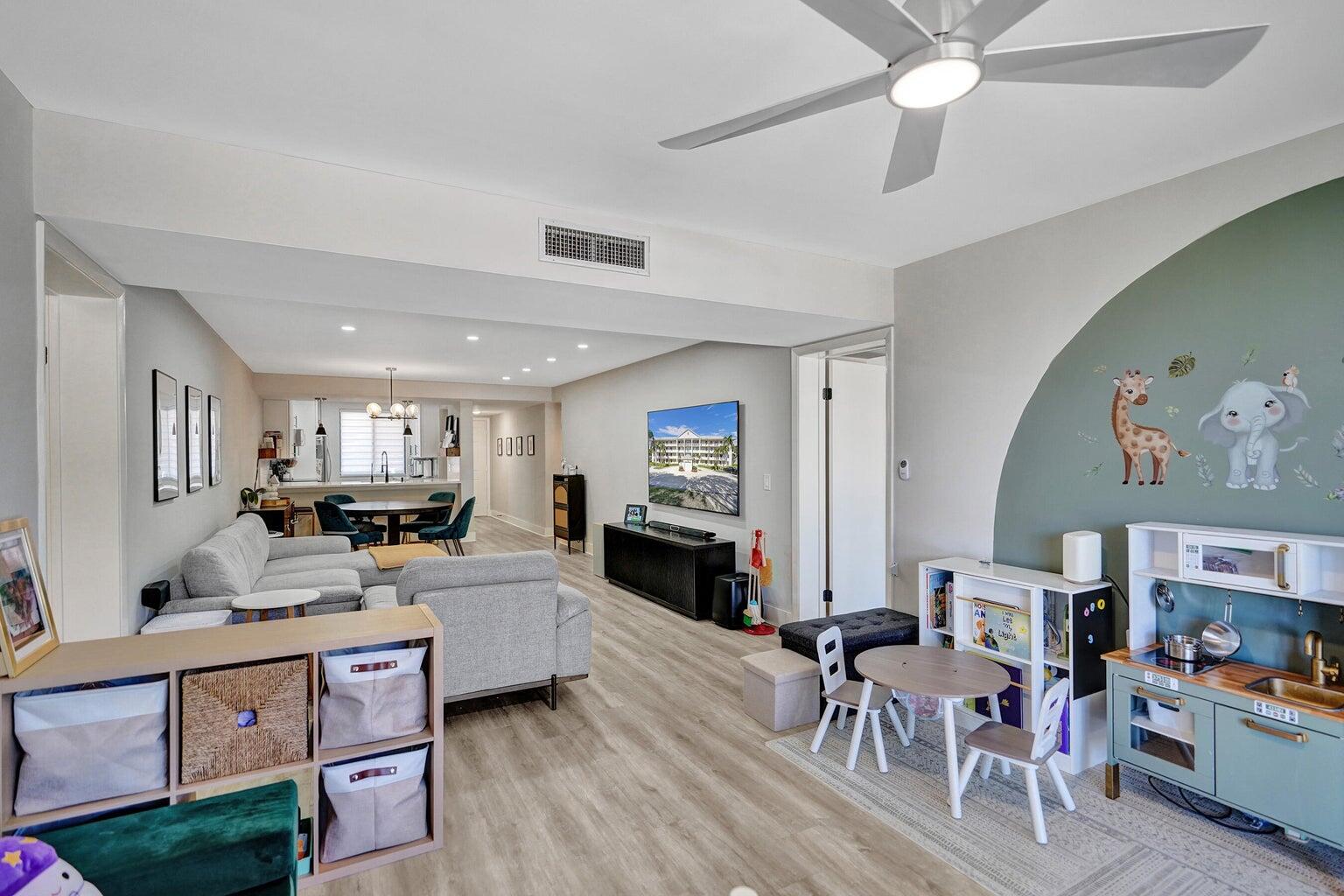 6193 Balboa Circle, Unit 201 Boca Raton, FL 33433 - Photo 27 of 62 a living room with fireplace furniture and a flat screen tv