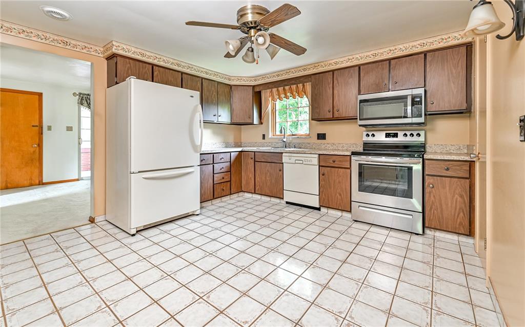 20 Gordon Street McKees Rocks, PA 15136 - Photo 3 of 25 a kitchen with stainless steel appliances granite countertop a refrigerator sink and stove
