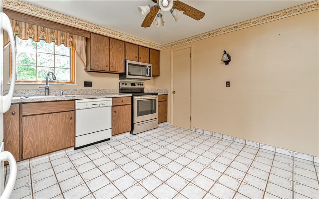 20 Gordon Street McKees Rocks, PA 15136 - Photo 4 of 25 a kitchen with a sink window and cabinets