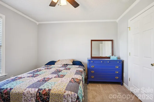 a bedroom with a bed and a dresser
