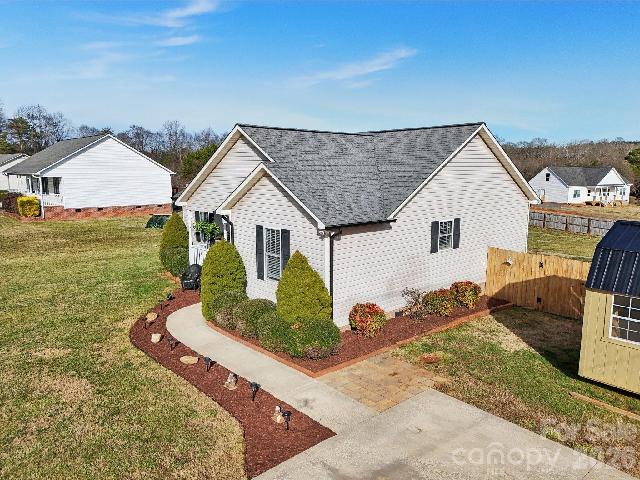 3802 Babe Lane Vale, NC 28168 - Photo 23 of 27 a view of a white house next to a yard with potted plants
