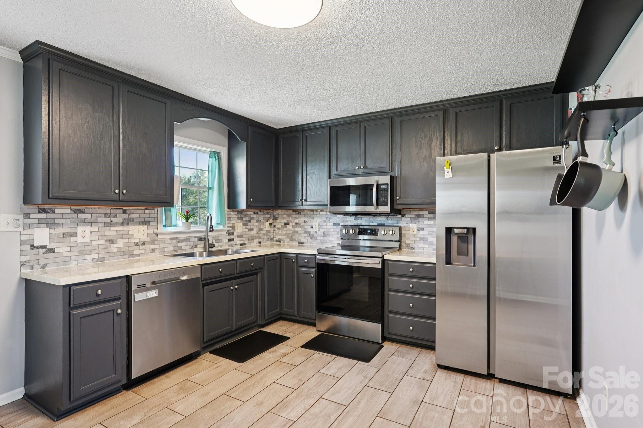 3802 Babe Lane Vale, NC 28168 - Photo 7 of 27 a kitchen with stainless steel appliances granite countertop a sink stove and refrigerator