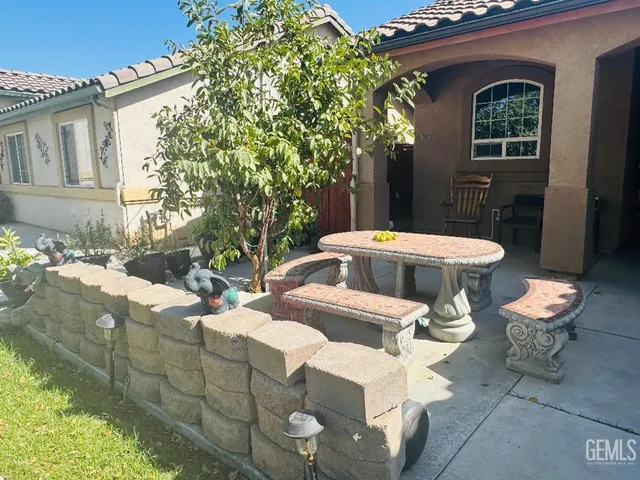 a view of a patio with table and chairs and potted plants