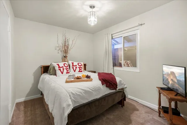 a bathroom with a granite countertop sink mirror vanity and toilet