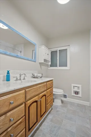 a view of a backyard with chairs potted plants and wooden fence